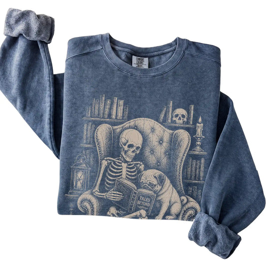 Folded Denim sweatshirt with a skeleton reading Tales Beyond to a Pug