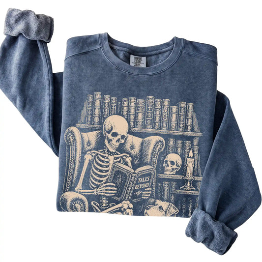 Folded Denim sweatshirt with a skeleton reading Tales Beyond to a Schnauzer
