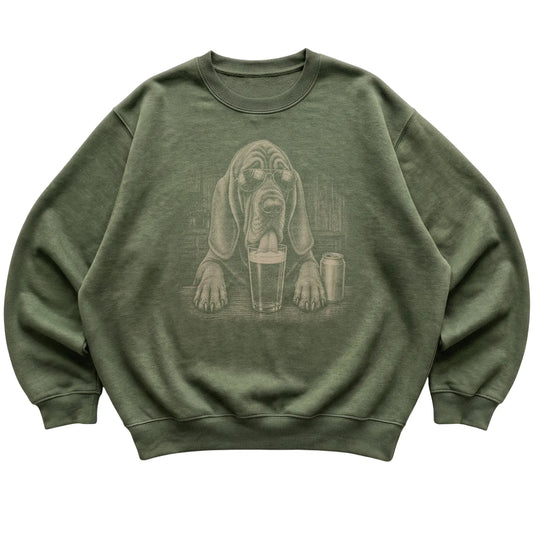 Military Green Bloodhound drinking from a pint at a bar, laid flat