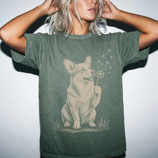 Model wearing a Moss Comfort Colors® T-shirt showing Corgi portrait with drifting dandelion seeds
