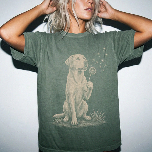 Model wearing a Moss Comfort Colors® T-shirt showing Labrador Retriever portrait with drifting dandelion seeds