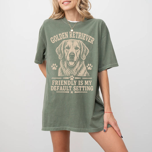 Model wearing a Moss Comfort Colors® T-shirt featuring Golden Retriever design with “Friendly Is My Default Setting” letterin