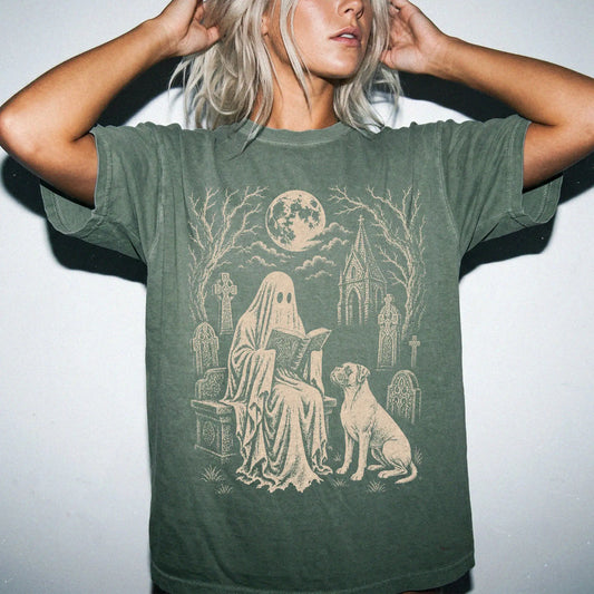 Model wearing a Moss Comfort Colors® T-shirt showing Boxer beside a reading ghost in a moonlit graveyard