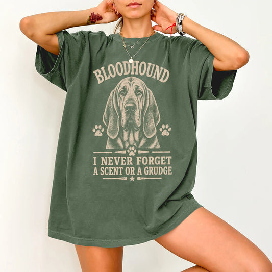 Model wearing a Moss Comfort Colors® T-shirt featuring Bloodhound design with “I Never Forget A Scent Or A Grudge” lettering