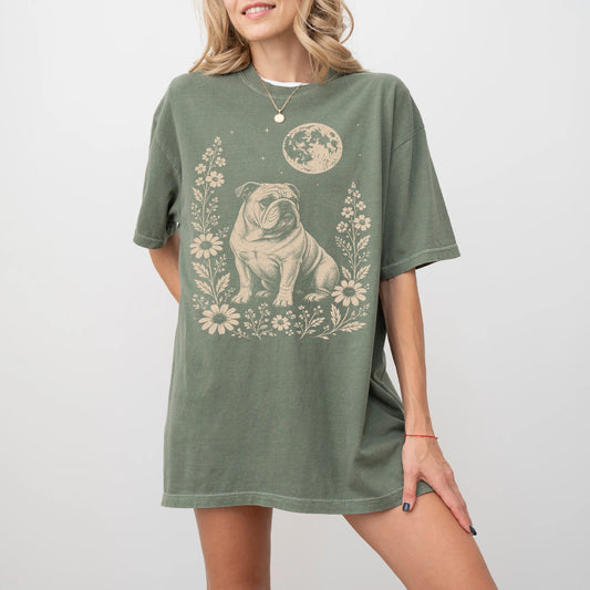 Model wearing a Moss Comfort Colors® T-shirt featuring Bulldog framed by flowers beneath the moon