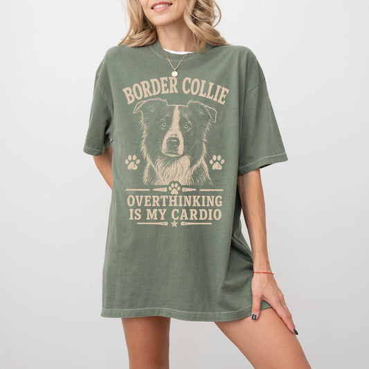 Model wearing a Moss Comfort Colors® T-shirt featuring Border Collie design with “Overthinking Is My Cardio” lettering
