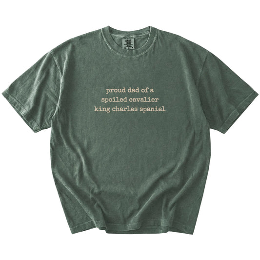 Proud Dad of a Spoiled Cavalier King Charles Spaniel lettering on a Moss Comfort Colors® T-shirt