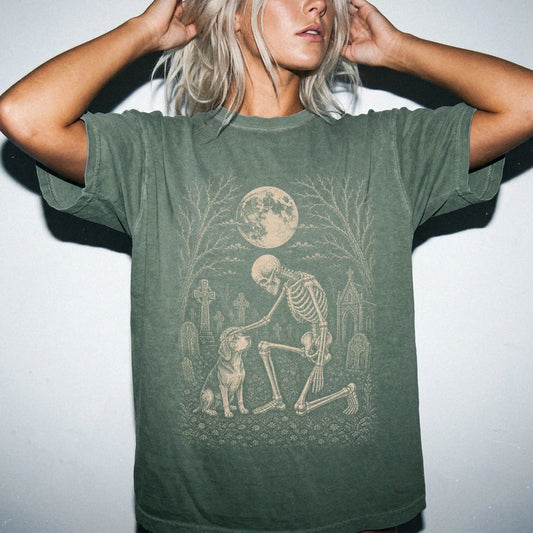 Model wearing a Moss Comfort Colors® T-shirt showing Beagle sharing a quiet cemetery moment with a friendly skeleton