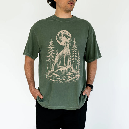 Model wearing a Moss Comfort Colors® T-shirt with a Weimaraner howling beneath the moon and pine trees