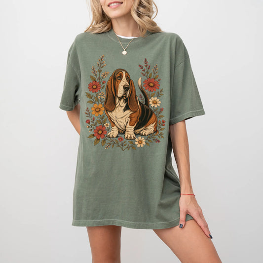 Model wearing a Moss Comfort Colors® T-shirt showing Basset Hound portrait surrounded by wildflowers beneath the moon