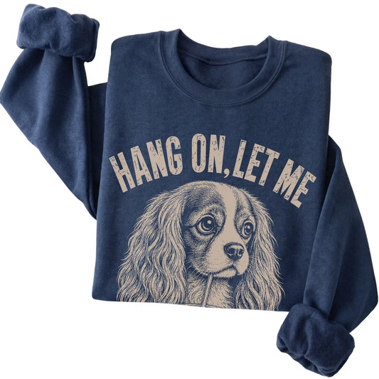 Navy crewneck sweatshirt featuring Overthinking Cavalier King Charles Spaniel, folded presentation