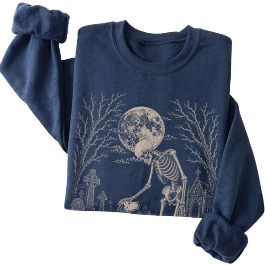 Folded Navy sweatshirt with a skeleton petting a Dalmatian in a graveyard
