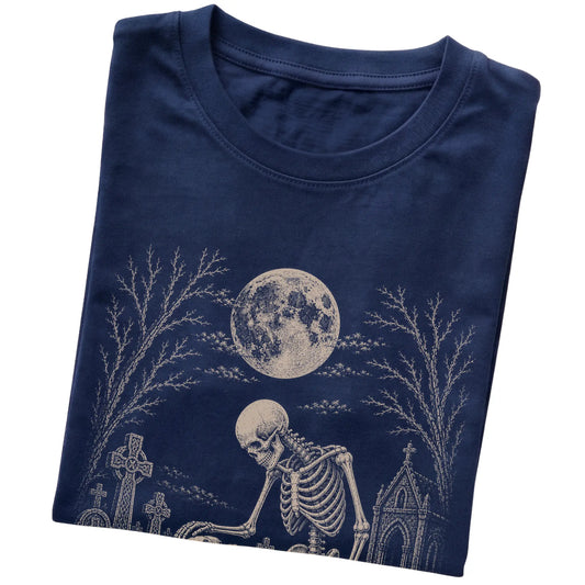 Folded Navy T-shirt with a skeleton petting a Pitbull in a graveyard