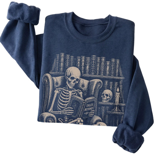 Folded Navy sweatshirt with a skeleton reading Tales Beyond to a Cocker Spaniel