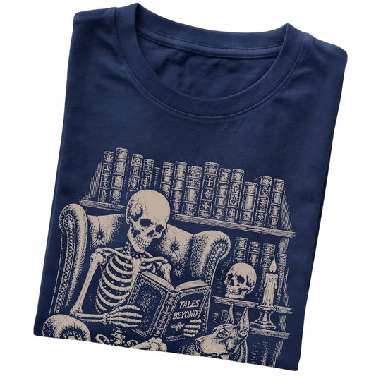 Folded Navy T-shirt with a skeleton reading Tales Beyond to a Doberman