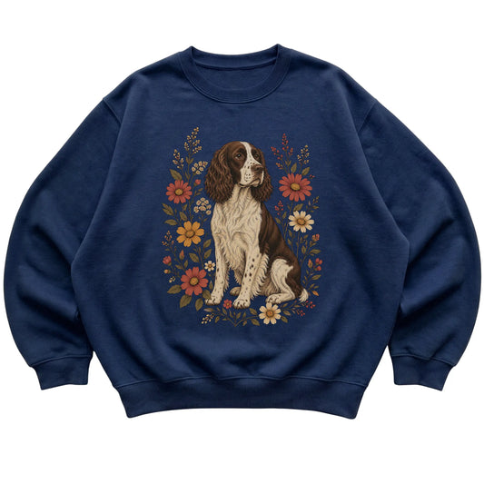 Navy crewneck sweatshirt with Springer Spaniel portrait and wildflowers, flat lay