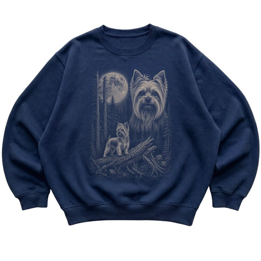 Yorkie Moonlit Forest graphic on a navy crewneck sweatshirt laid flat