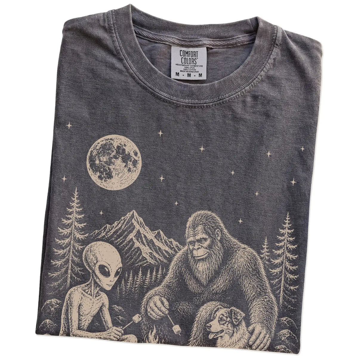 Folded Pepper Comfort Colors® T-shirt showing Australian Shepherd camping with Bigfoot and an alien