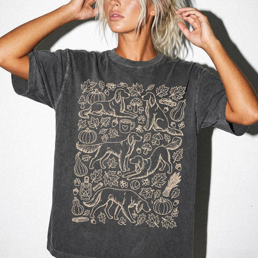 Model wearing a Pepper Comfort Colors® T-shirt with Irish Setter dogs with pumpkins, leaves, acorns, and woodland details