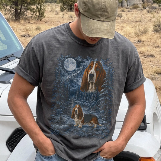 Model wearing a pepper T-shirt with Basset Hound Winter Moon artwork.