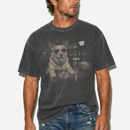 Model wearing a Pepper Comfort Colors® T-shirt featuring Blue Heeler with beer and football graphics