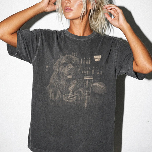 Model wearing a Pepper Comfort Colors® T-shirt featuring Newfie with beer and football graphics