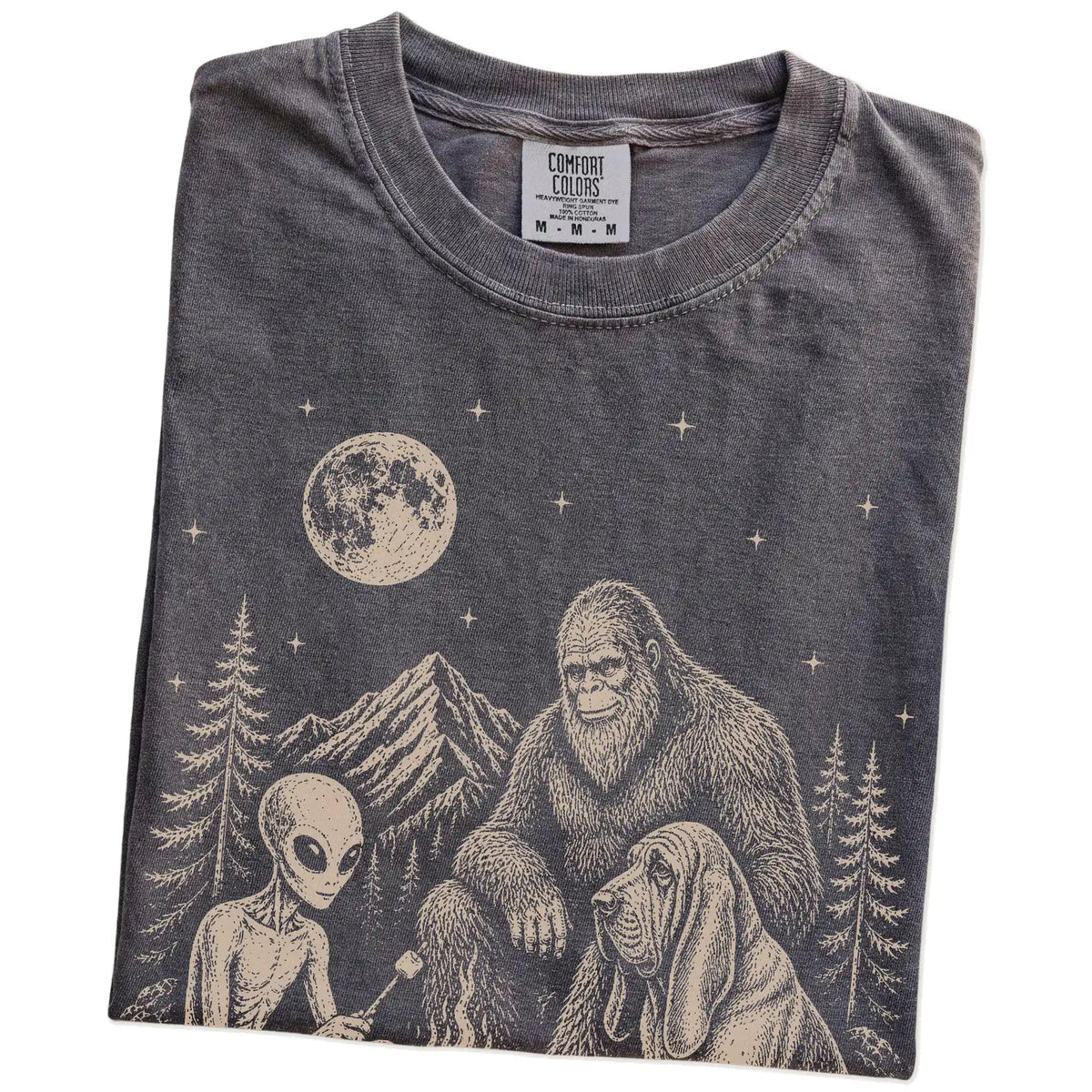 Folded Pepper Comfort Colors® T-shirt showing Bloodhound camping with Bigfoot and an alien