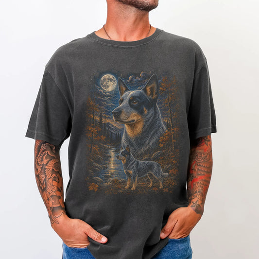 Model wearing a Pepper Comfort Colors® t-shirt featuring Blue Heeler in a moonlit fall forest