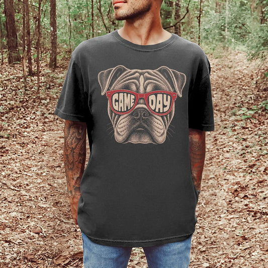 Model wearing a Pepper Comfort Colors® T-shirt with bulldog wearing red game day sunglasses