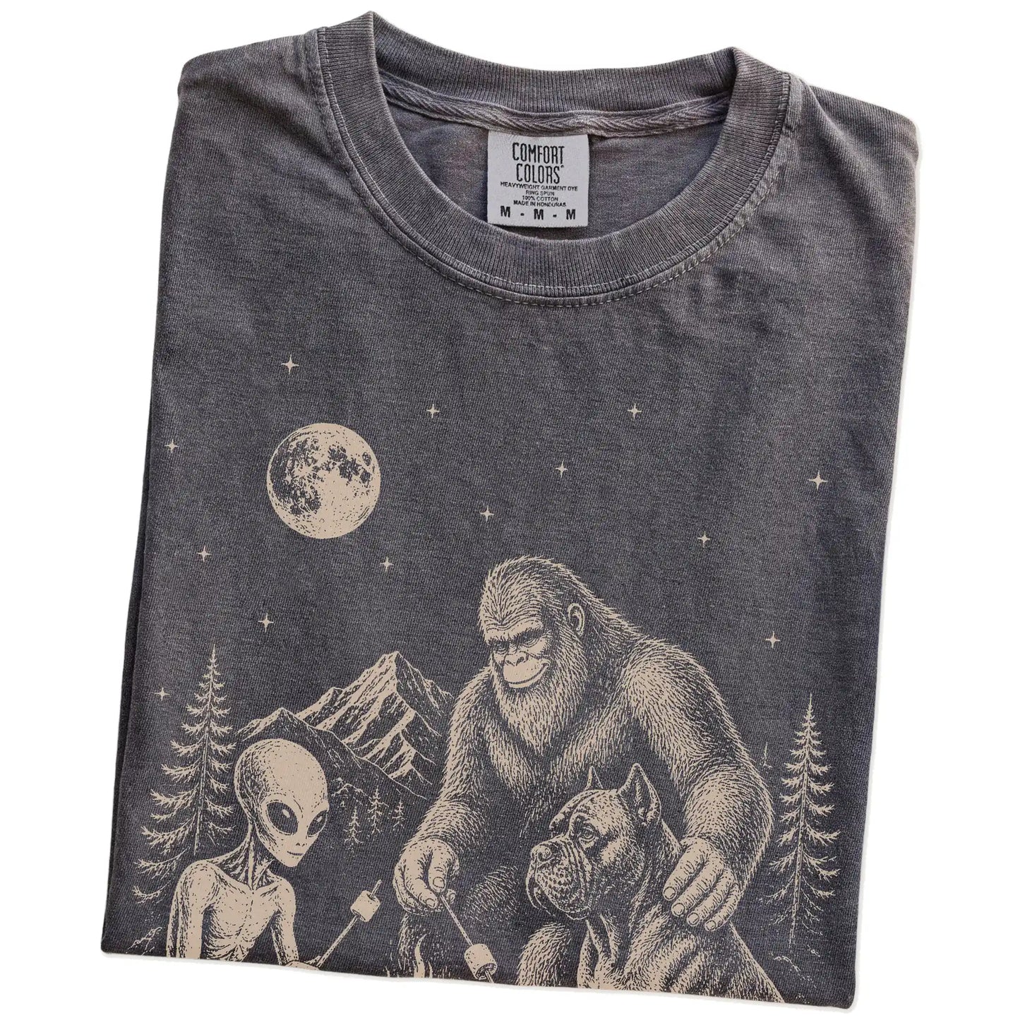 Folded Pepper Comfort Colors® T-shirt showing Cane Corso camping with Bigfoot and an alien