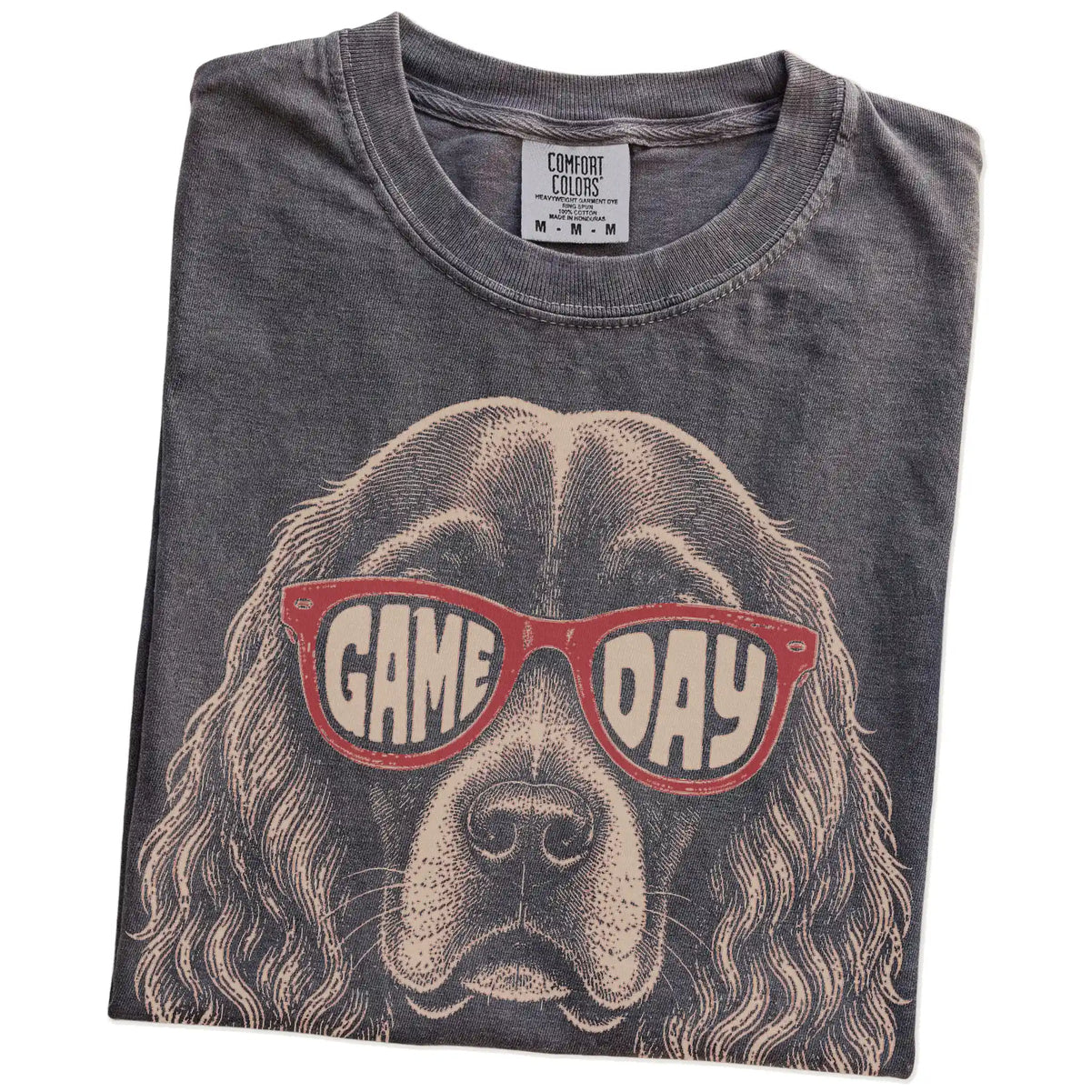 Folded Pepper Comfort Colors® T-shirt showing cocker spaniel wearing red game day sunglasses