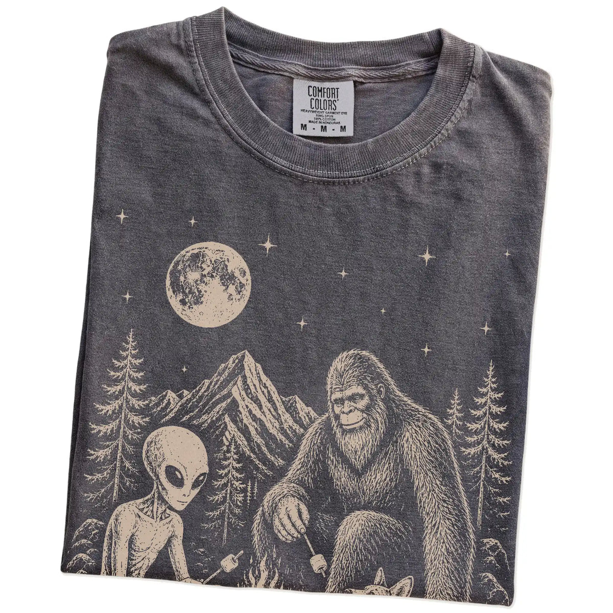 Folded Pepper Comfort Colors® T-shirt showing Corgi camping with Bigfoot and an alien