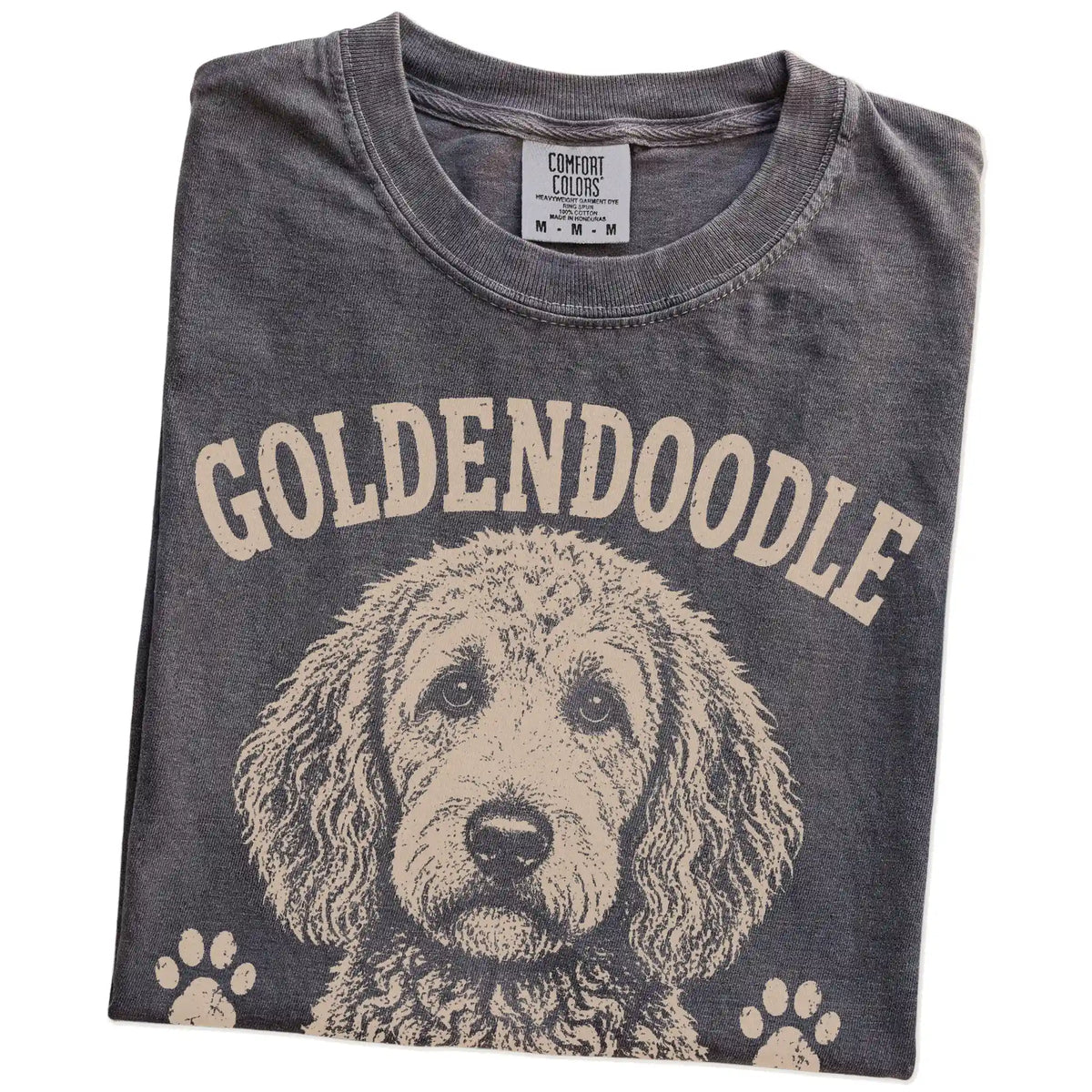 Folded Pepper Comfort Colors® T-shirt showing Goldendoodle design with “Curly Hair, Don't Care” lettering