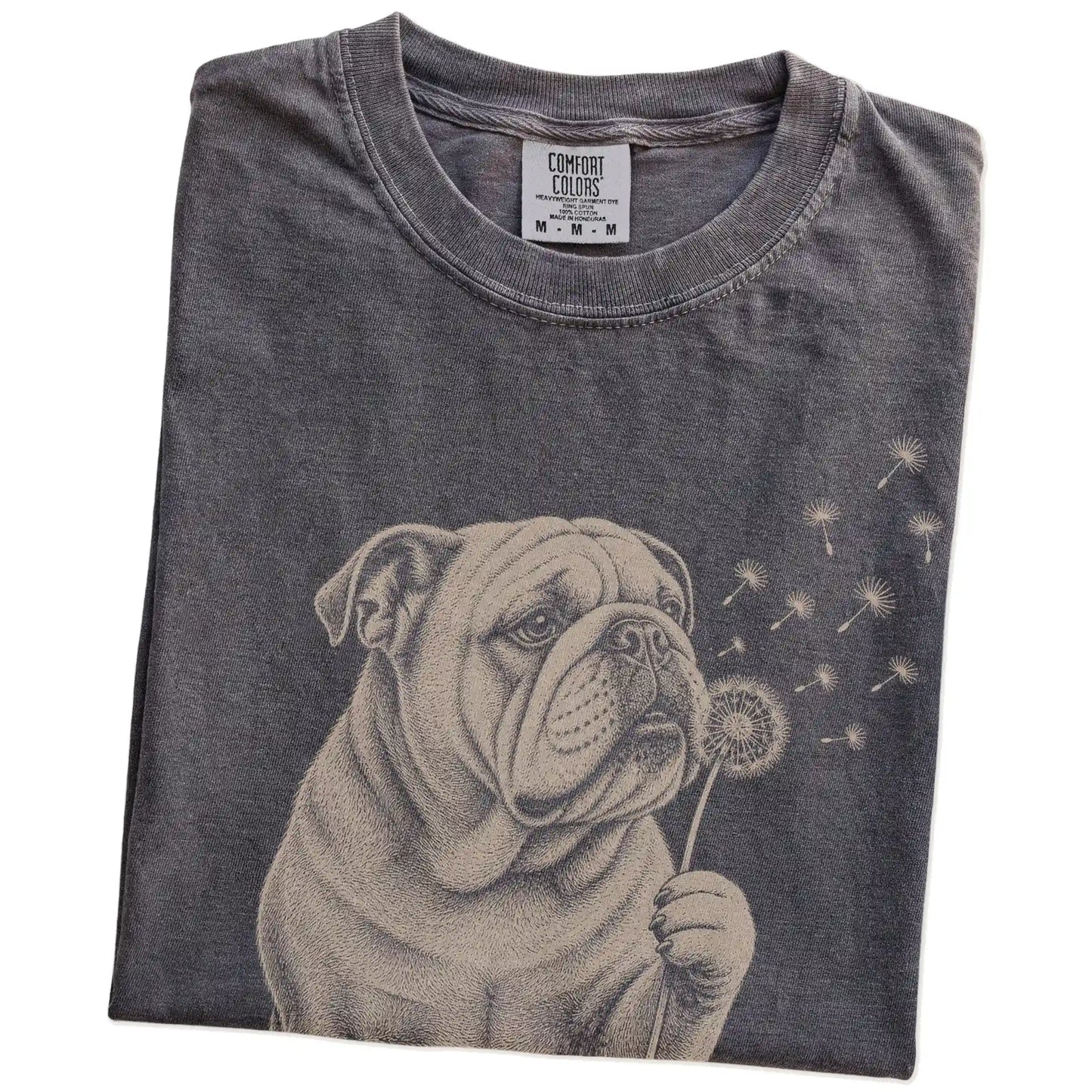 Folded Pepper Comfort Colors® T-shirt showing Bulldog portrait with drifting dandelion seeds