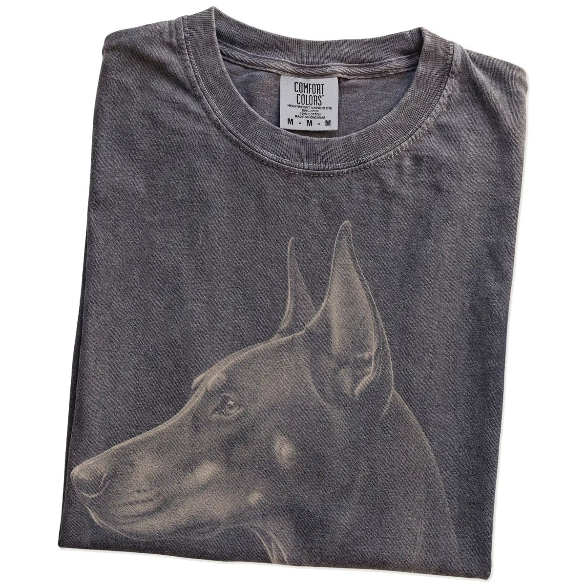 Folded Pepper Comfort Colors® T-shirt showing a detailed photographic portrait of a Doberman