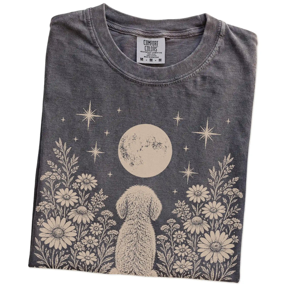 Folded Pepper Comfort Colors® T-shirt showing Goldendoodle beneath a wildflower moon