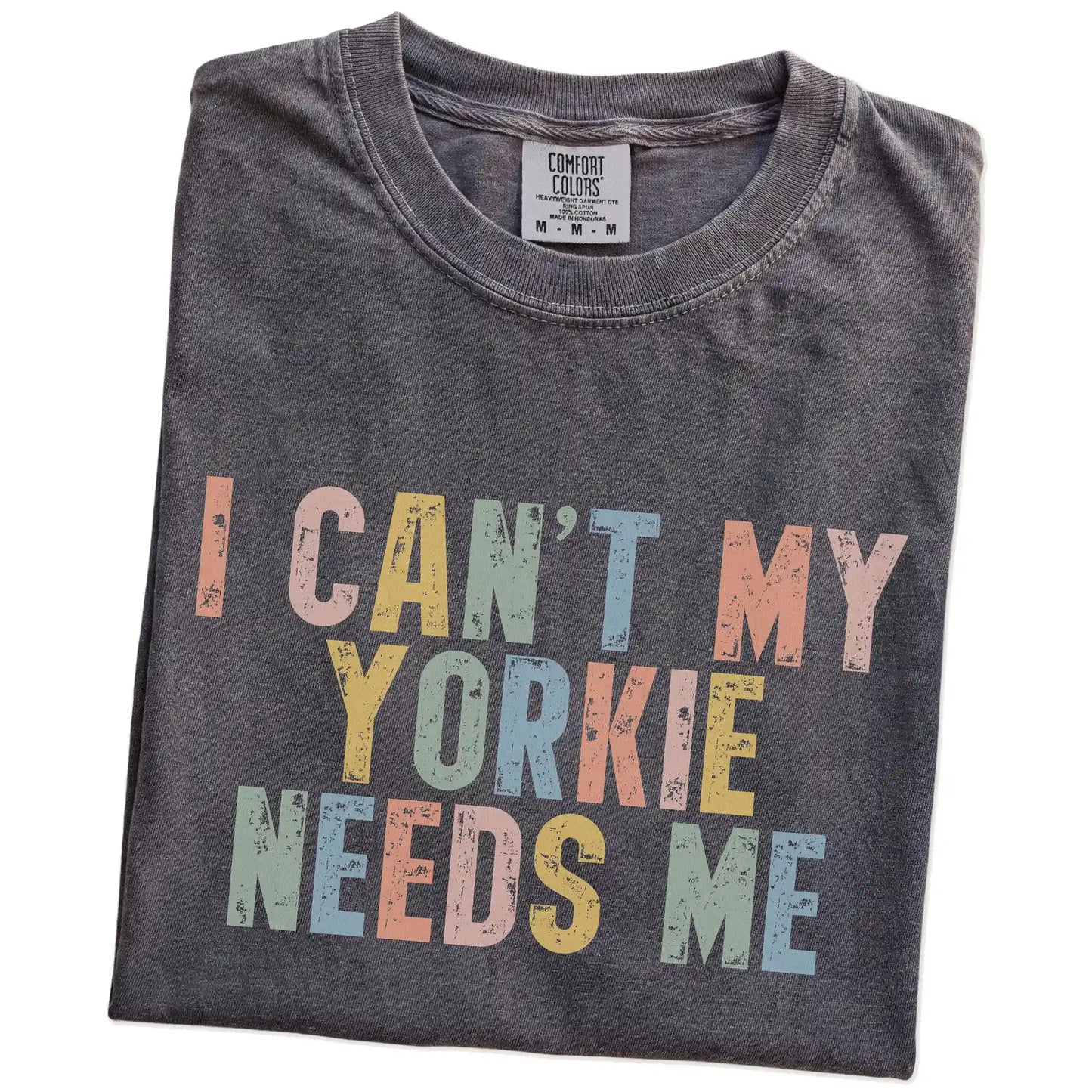 Folded Pepper Comfort Colors® T-shirt showing Yorkie with “I Can’t, My Dog Needs Me” lettering