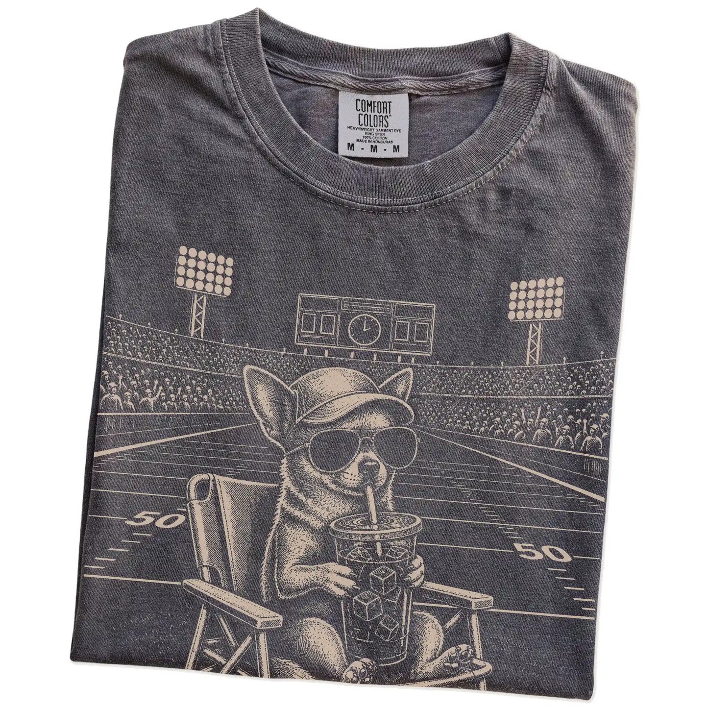 Folded Pepper Comfort Colors® T-shirt showing Chihuahua claiming the football field with “I Live Here Now” lettering