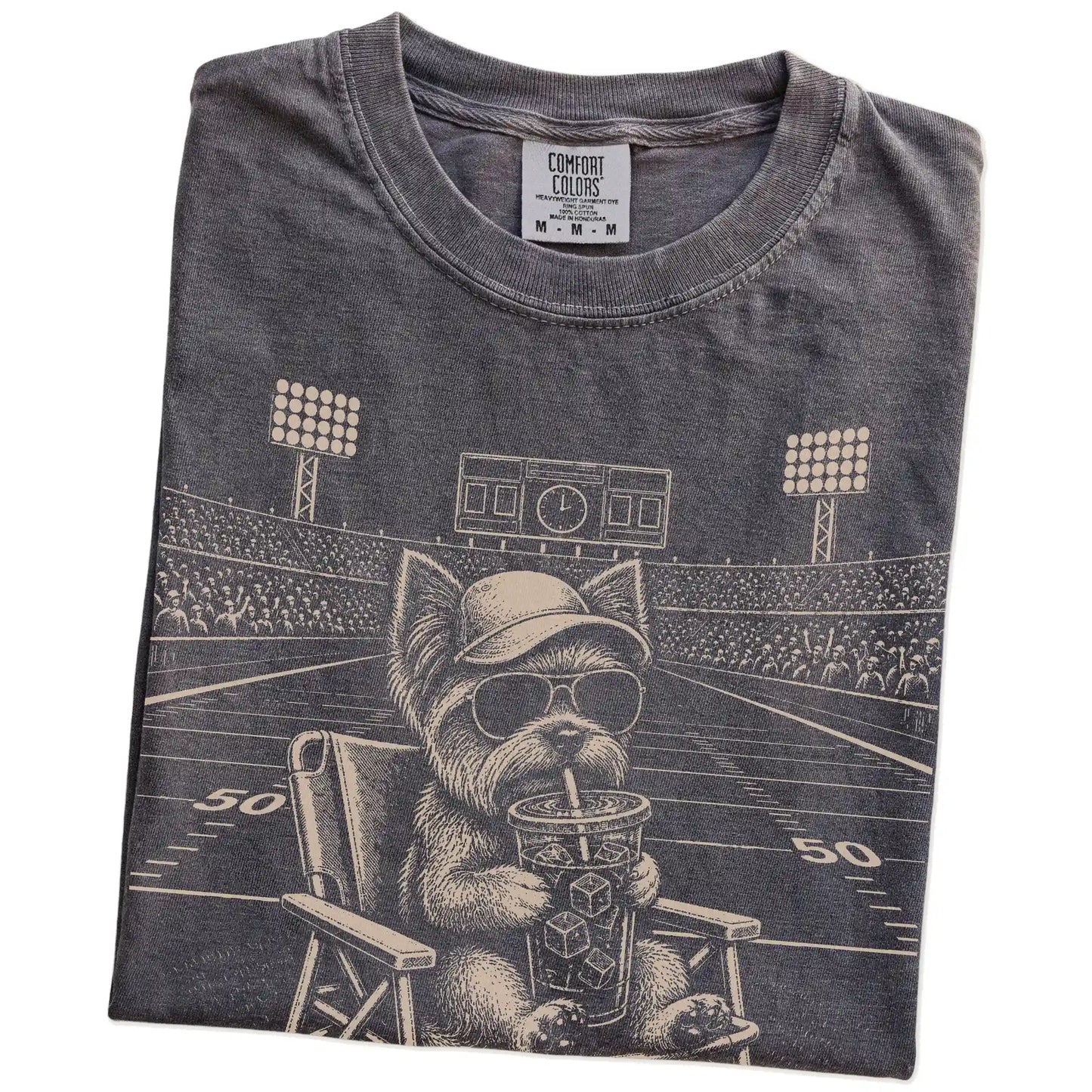 Folded Pepper Comfort Colors® T-shirt showing Yorkie claiming the football field with “I Live Here Now” lettering