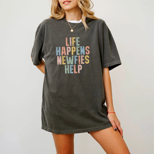 Model wearing a Pepper Comfort Colors® T-shirt featuring Newfie making hard days better with “Life Happens, Dogs Help” letter