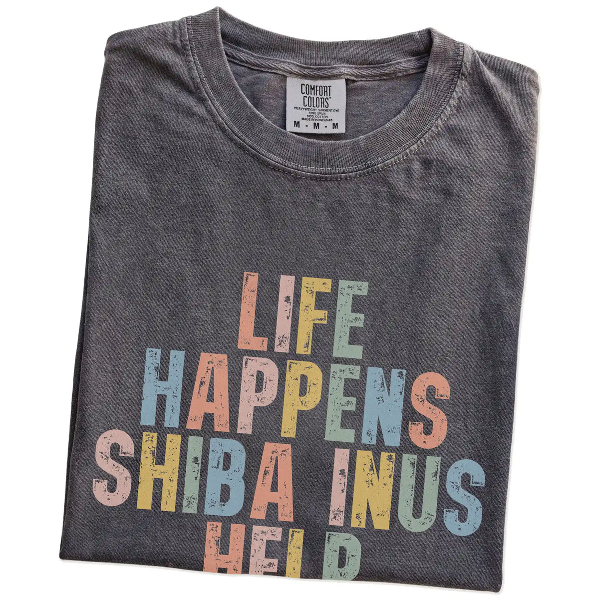 Folded Pepper Comfort Colors® T-shirt showing retro “Life Happens, Shiba Inus Help” lettering