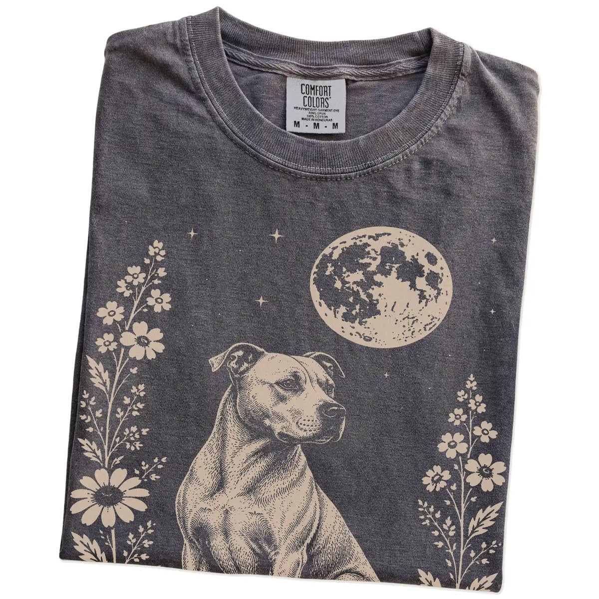 Folded Pepper Comfort Colors® T-shirt showing Pitbull framed by flowers beneath the moon