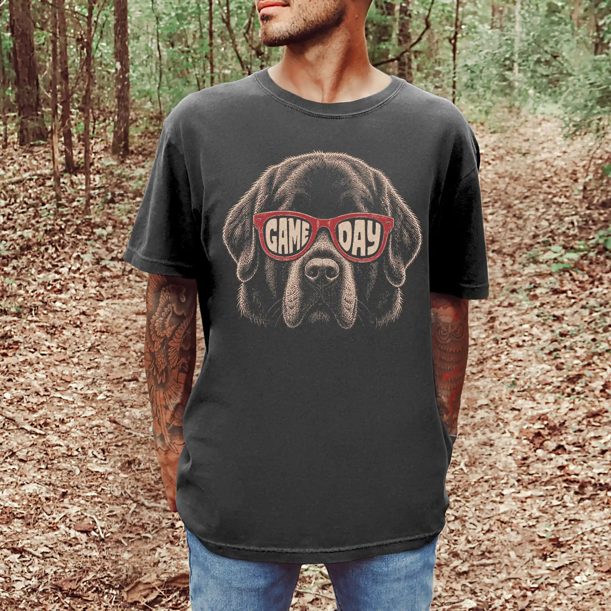Model wearing a Pepper Comfort Colors® T-shirt with newfie wearing red game day sunglasses