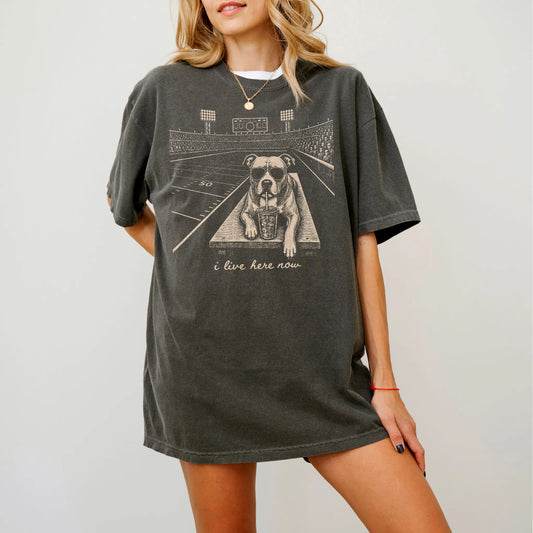 Model wearing a Pepper Comfort Colors® T-shirt featuring Pitbull ready for football and tailgate season