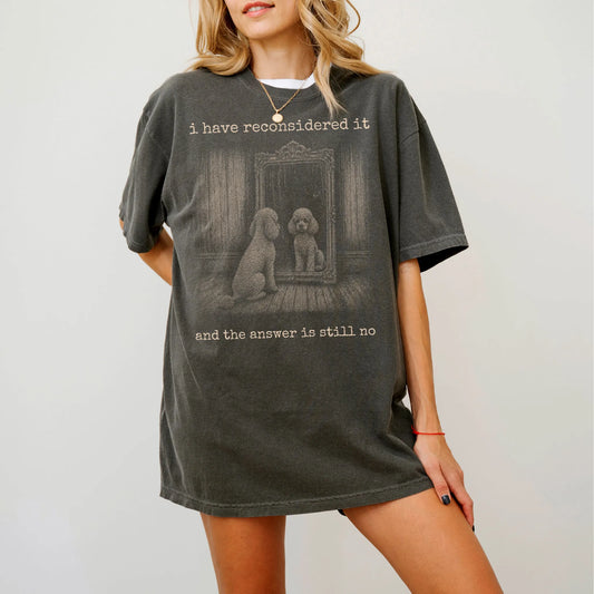 Model wearing a Pepper Comfort Colors® T-shirt with “the answer is still no” poodle design