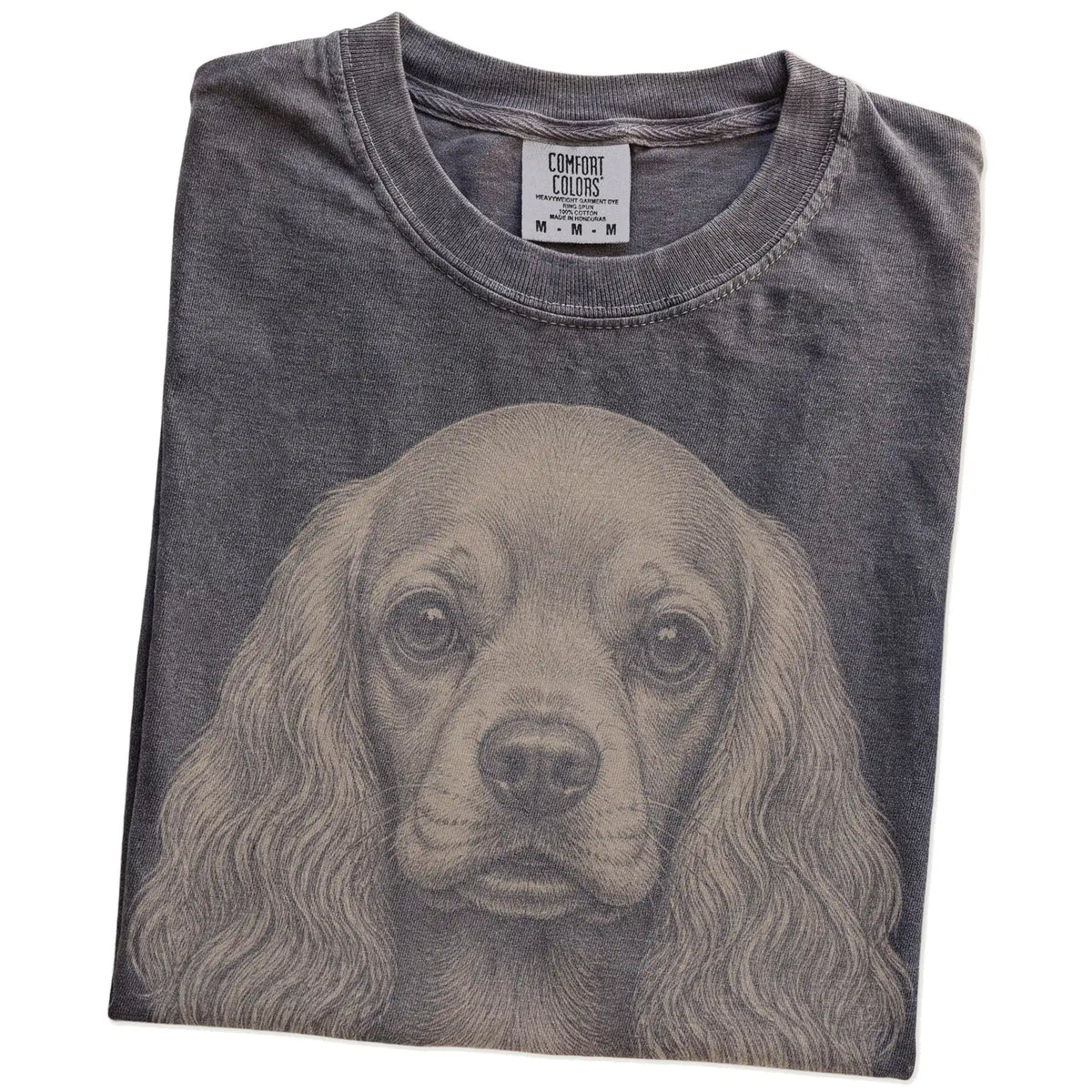 Folded Pepper Comfort Colors® T-shirt showing a realistic drawing of a Cocker Spaniel