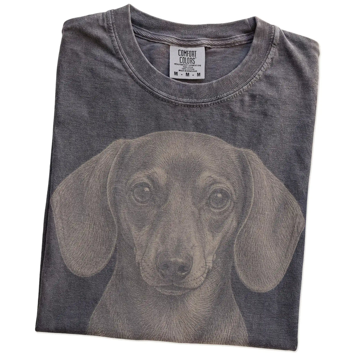 Folded Pepper Comfort Colors® T-shirt showing a realistic drawing of a Dachshund