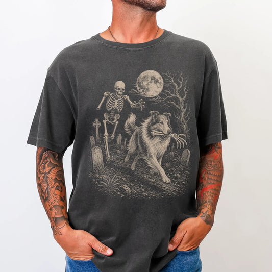 Model wearing a Pepper Comfort Colors® T-shirt showing Collie running through a moonlit graveyard with a chasing skeleton