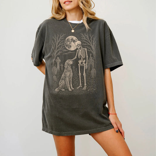Model wearing a Pepper Comfort Colors® T-shirt showing Irish Setter sharing a quiet cemetery moment with a friendly skeleton