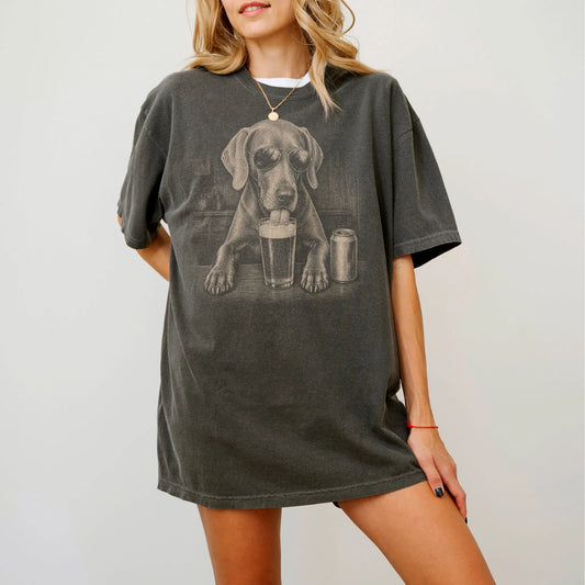 Model wearing a Pepper Comfort Colors® t-shirt with Weimaraner sneaking a drink from a pint